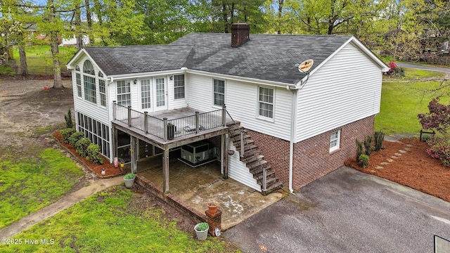 379 Greenbrier Rd, Tarboro, NC 27886 - rear view of property with a yard, stairs, a chimney, a shingled roof, and a deck