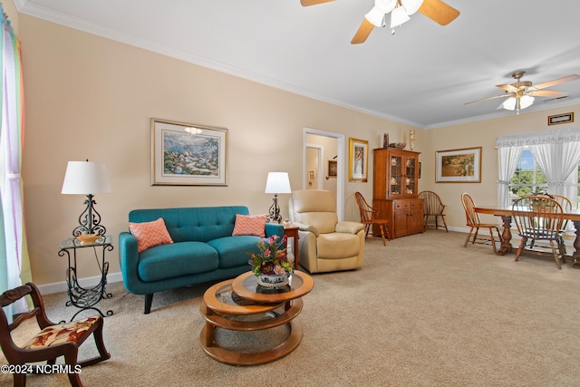 living room with a ceiling fan, light carpet, and ornamental molding