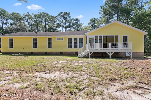 rear view of property with a lawn, a sunroom, and crawl space