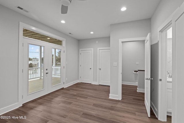 interior space featuring a ceiling fan, visible vents, recessed lighting, wood finished floors, and french doors