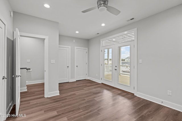 unfurnished bedroom featuring access to outside, baseboards, french doors, visible vents, and wood finished floors