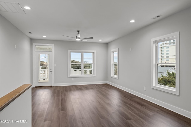 unfurnished room featuring visible vents, baseboards, ceiling fan, dark wood-style floors, and recessed lighting