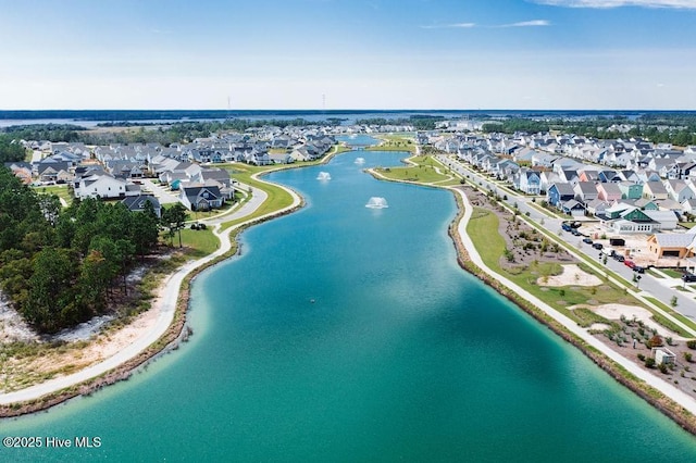 aerial view of residential area featuring a large body of water