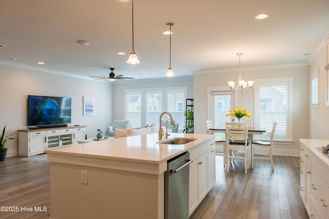 kitchen with a sink, stainless steel dishwasher, dark wood-style floors, white cabinets, and ornamental molding