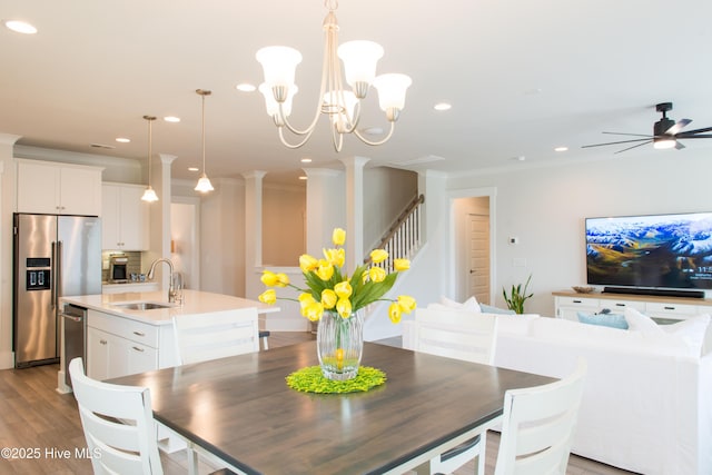 dining area featuring stairs, recessed lighting, light wood-style floors, ornate columns, and a ceiling fan