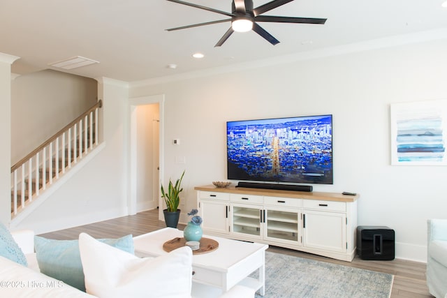 living room with stairs, light wood finished floors, ceiling fan, baseboards, and recessed lighting