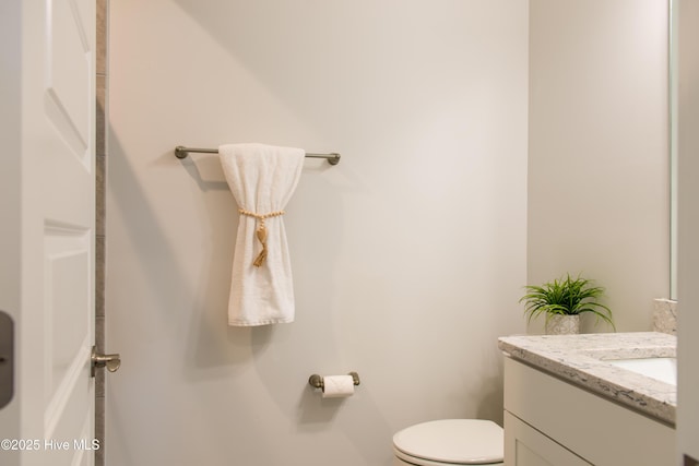bathroom featuring toilet and vanity