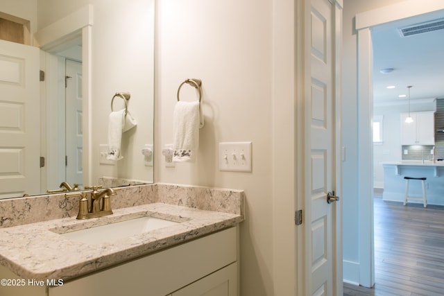bathroom featuring wood finished floors and vanity