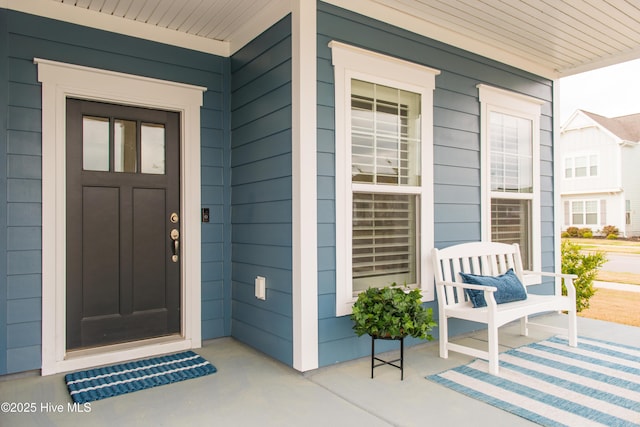 view of exterior entry with covered porch