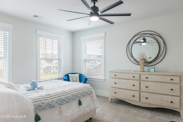 bedroom featuring light colored carpet, baseboards, and a ceiling fan