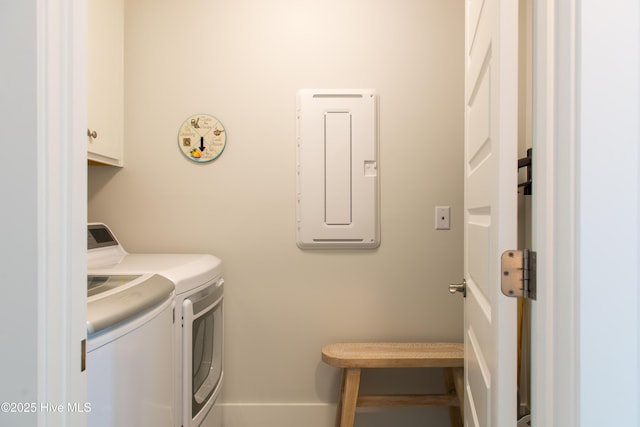 clothes washing area featuring washer and clothes dryer and cabinet space