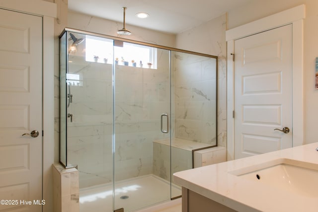 full bath with a marble finish shower, vanity, and recessed lighting