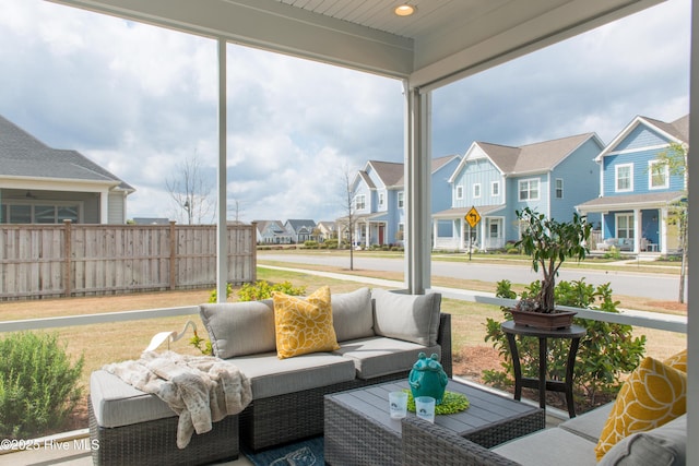 sunroom featuring a residential view and outdoor lounge area