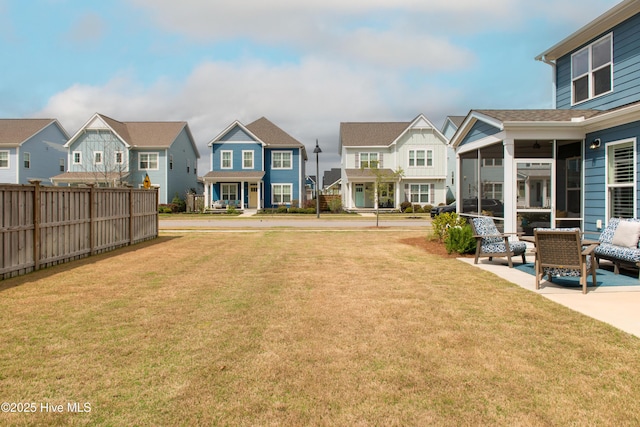 rear view of house with a residential view and a sunroom