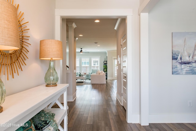 hallway with recessed lighting, dark wood-style floors, and baseboards
