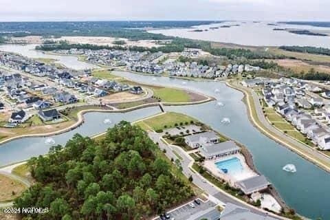 aerial view of property and surrounding area featuring a nearby body of water