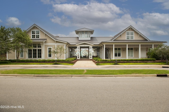 view of front of home featuring a standing seam roof, covered porch, and metal roof