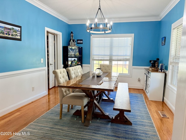 165 Laurel Oak Ln, Pinebluff, NC 28373 - dining room featuring a chandelier, light wood-type flooring, ornamental molding, and wainscoting