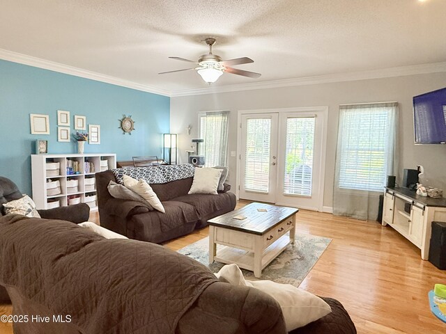 165 Laurel Oak Ln, Pinebluff, NC 28373 - living room featuring crown molding, light wood finished floors, ceiling fan, a textured ceiling, and french doors