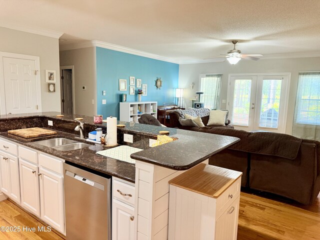 165 Laurel Oak Ln, Pinebluff, NC 28373 - kitchen with dishwasher, a sink, open floor plan, light wood-style floors, and crown molding