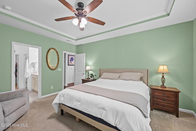 7351 Bellacroft Dr, Leland, NC 28451 - carpeted bedroom featuring baseboards, a tray ceiling, ornamental molding, and ensuite bathroom