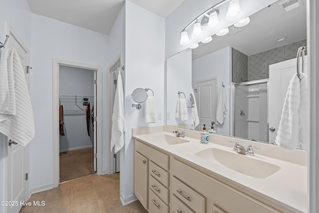 7351 Bellacroft Dr, Leland, NC 28451 - bathroom with a shower stall, double vanity, a spacious closet, baseboards, and tile patterned floors