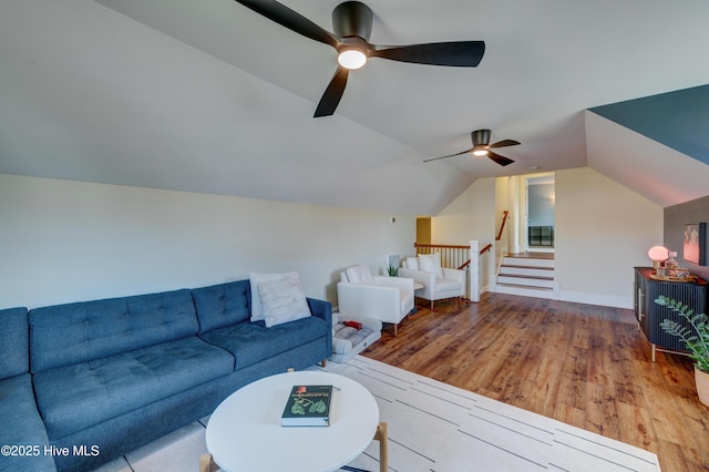 living area with vaulted ceiling, a ceiling fan, and wood finished floors