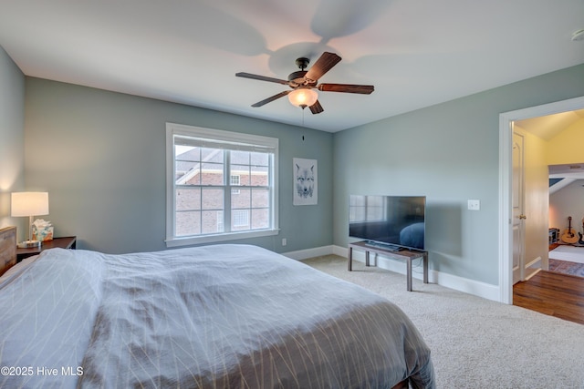 carpeted bedroom featuring baseboards and a ceiling fan