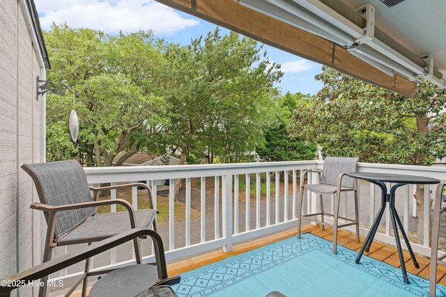 balcony featuring view of scattered trees