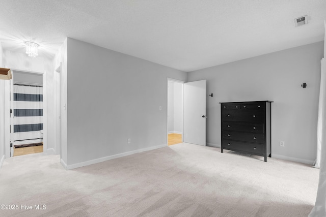unfurnished bedroom featuring carpet floors and baseboards