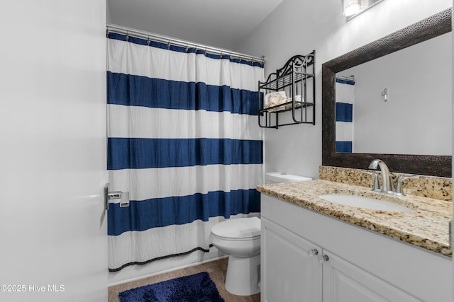 bathroom with toilet and vanity