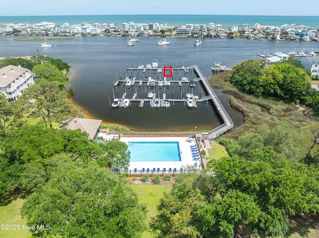 bird's eye view of a large body of water, a pool, and a marina