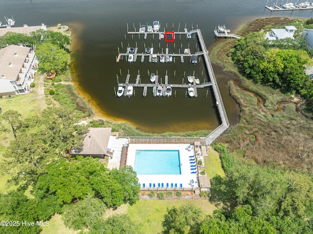 bird's eye view of a large body of water, a marina, and a pool area