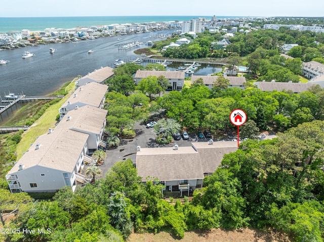 drone / aerial view of a large body of water and a tree filled landscape