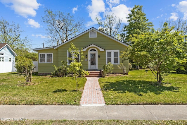 bungalow-style home featuring a front yard