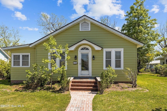 bungalow-style house with a front lawn