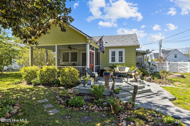 rear view of house featuring ceiling fan, roof with shingles, fence, an outdoor hangout area, and a patio