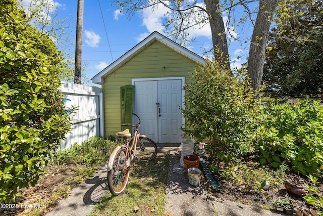 view of shed featuring fence