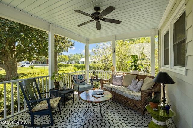 sunroom / solarium featuring ceiling fan and an outdoor hangout area