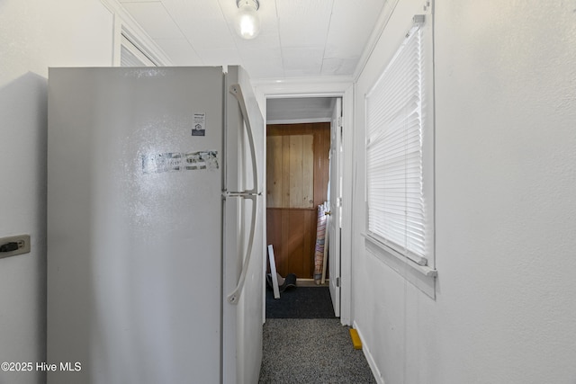 hall featuring carpet flooring