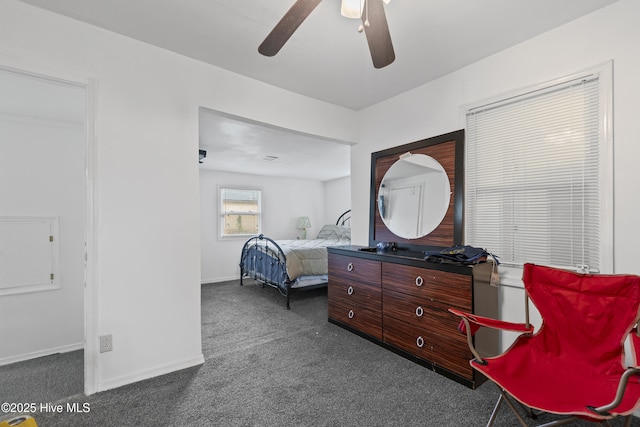 bedroom featuring dark colored carpet, baseboards, and ceiling fan