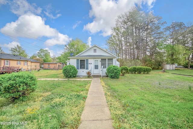 bungalow-style home featuring a front lawn