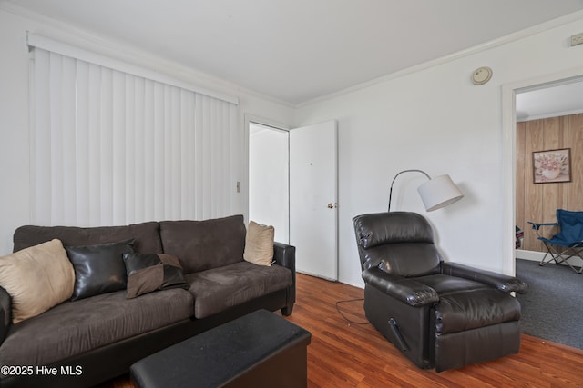 living area featuring wood finished floors and ornamental molding
