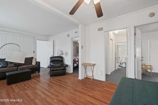 living room featuring ceiling fan, crown molding, and wood finished floors