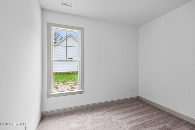 unfurnished room featuring visible vents, carpet flooring, and baseboards