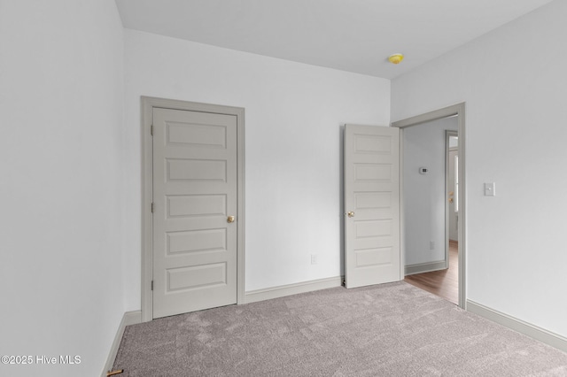 unfurnished bedroom with baseboards and carpet flooring