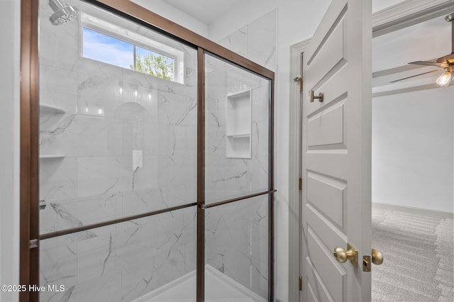 bathroom featuring a marble finish shower and a ceiling fan