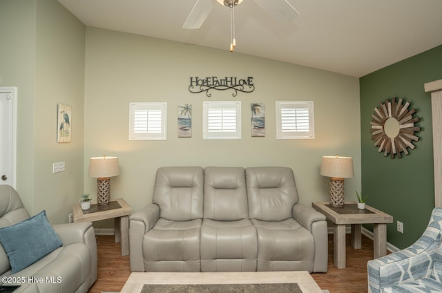 living room with baseboards, plenty of natural light, vaulted ceiling, and wood finished floors