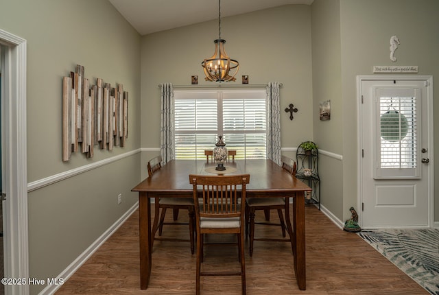 dining space featuring baseboards, an inviting chandelier, vaulted ceiling, and dark wood finished floors