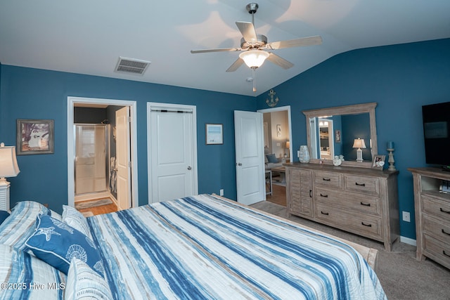 carpeted bedroom featuring ceiling fan, ensuite bath, vaulted ceiling, visible vents, and baseboards
